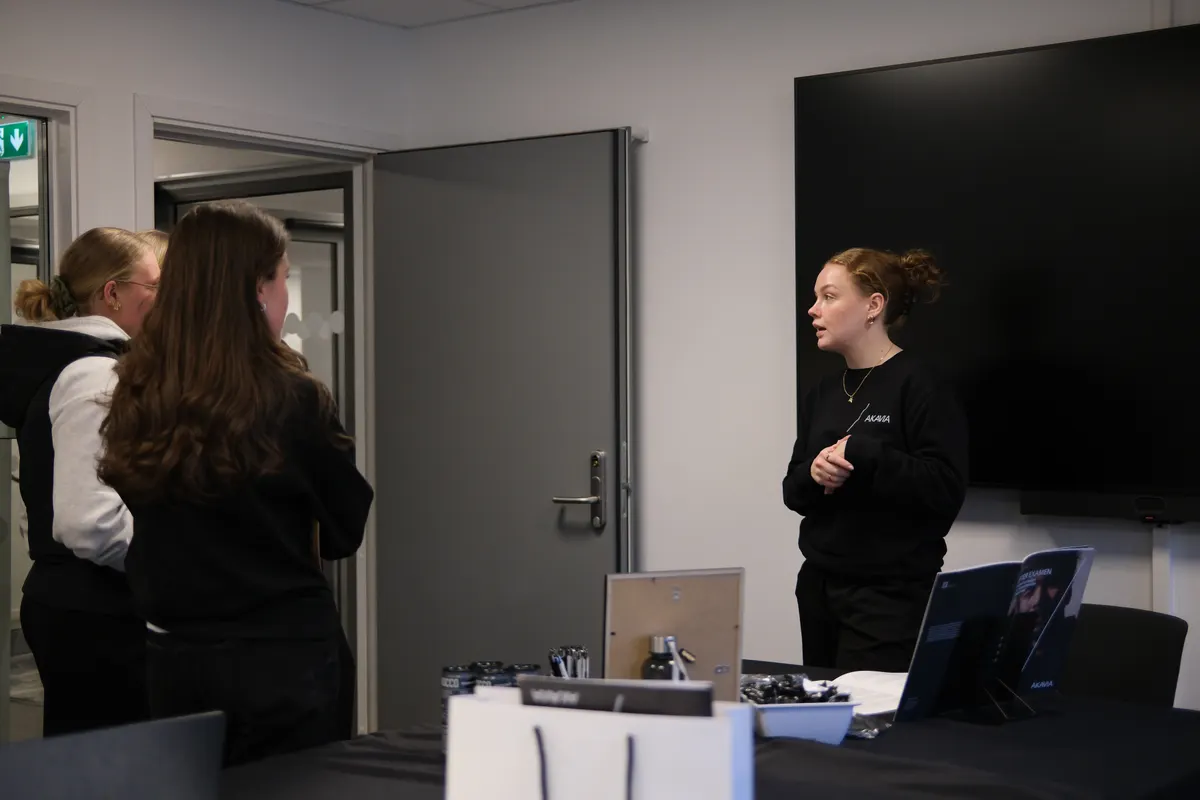 An Orbi ambassador talking with students at a campus event.