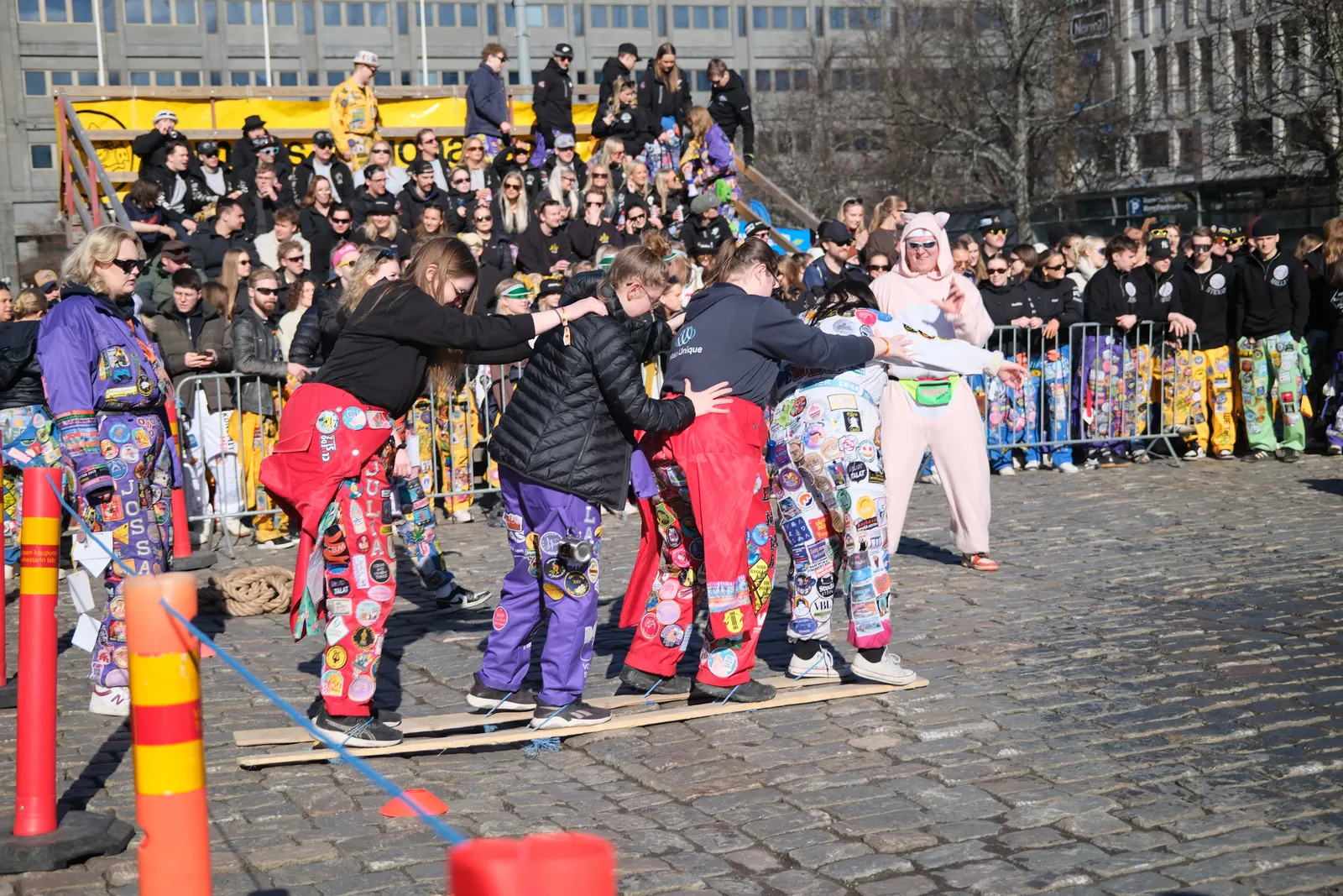 Teams competing in the Olympiad in front of a crowd.