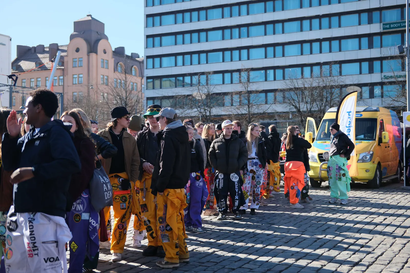 Students queuing in the square to collect their wristbands.